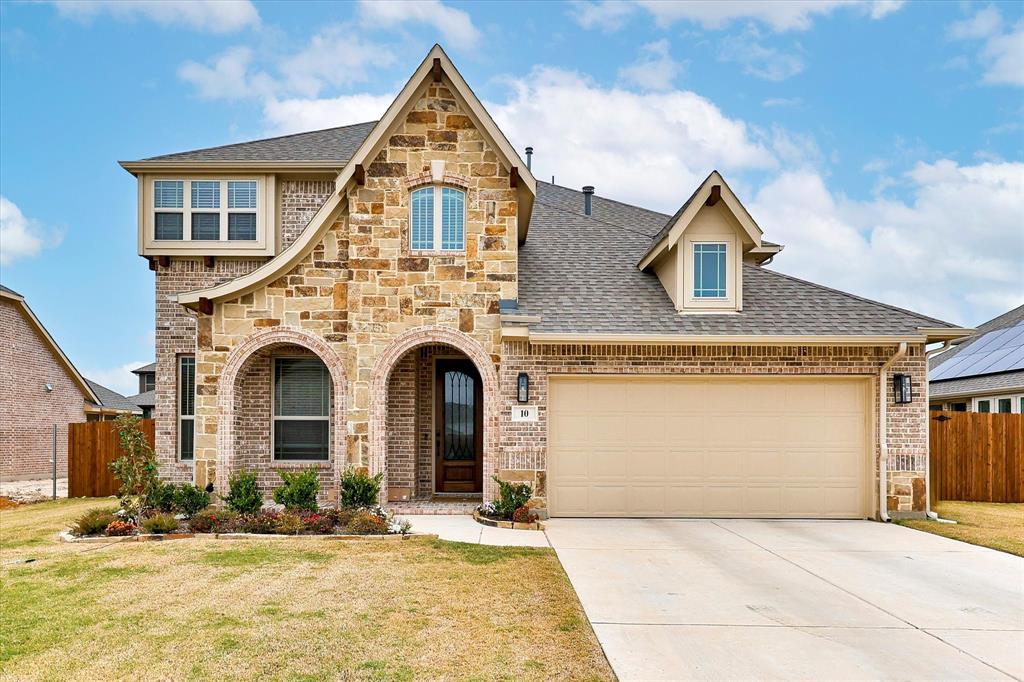 View of front of home with a garage and a front yard