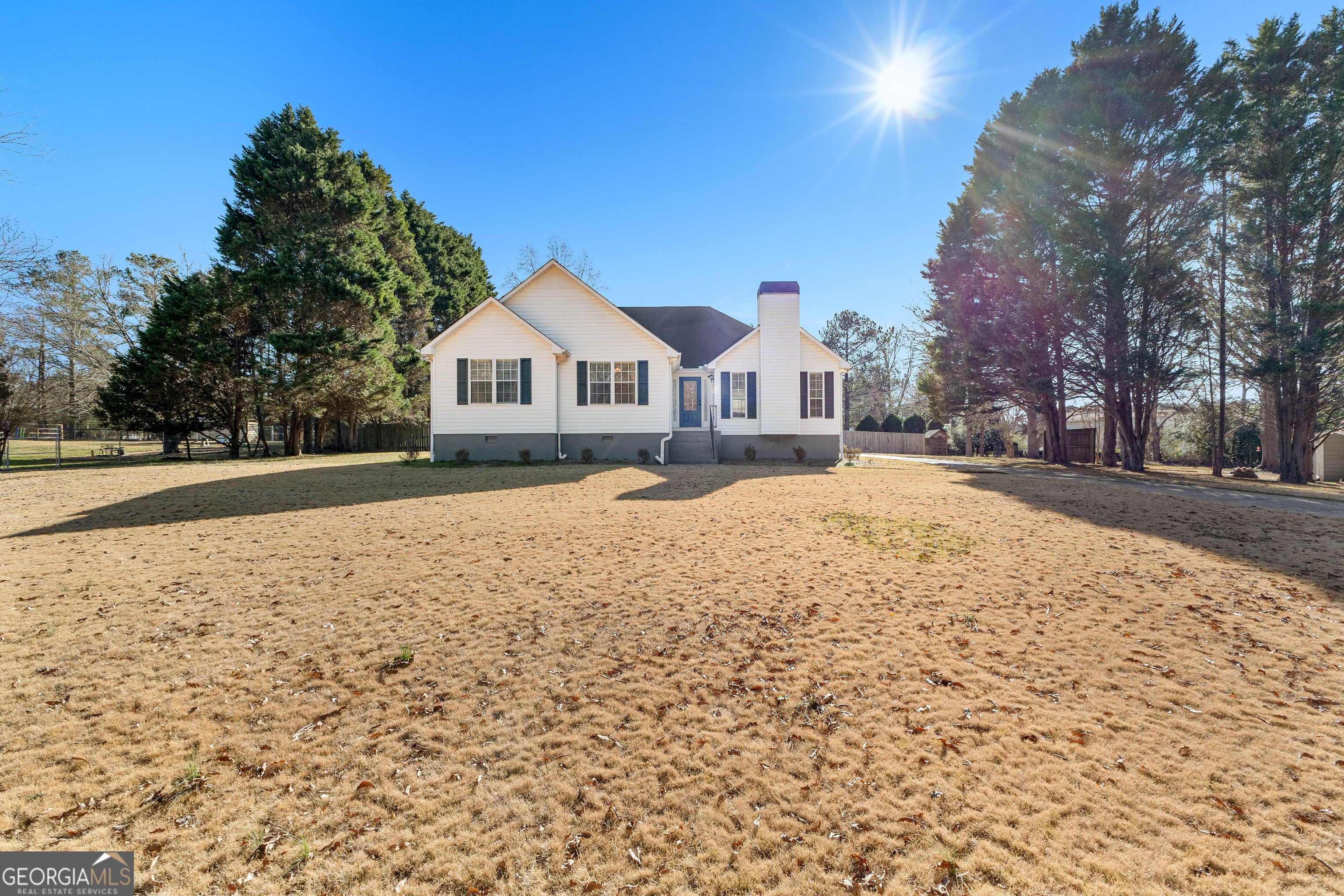 a view of the house with a yard covered in snow