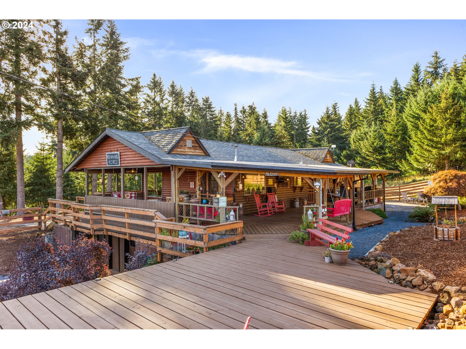 a view of a house with wooden deck and furniture