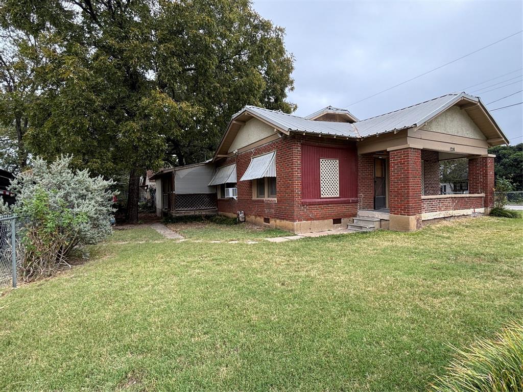 a front view of house with yard and seating area