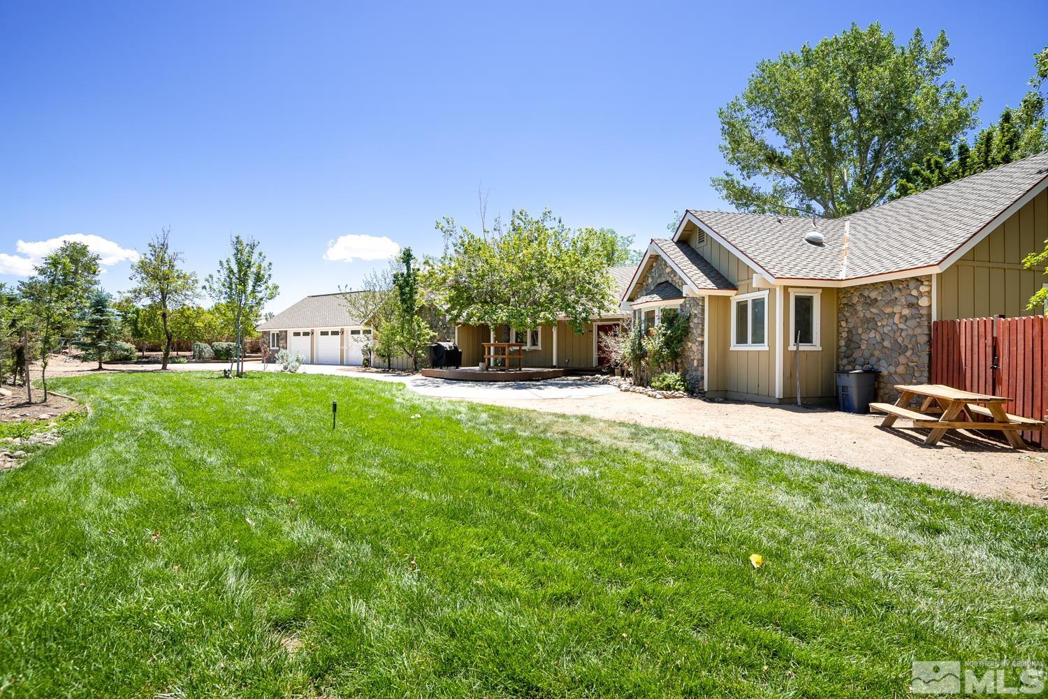 a front view of a house with a garden and yard