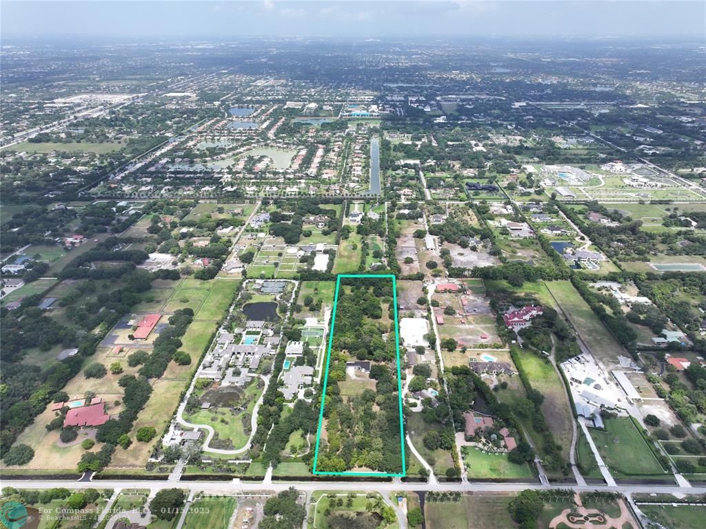 an aerial view of residential houses with city view