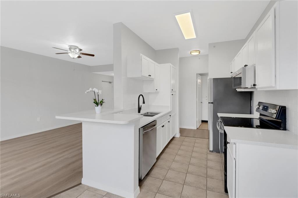 a kitchen with stainless steel appliances a sink stove and refrigerator