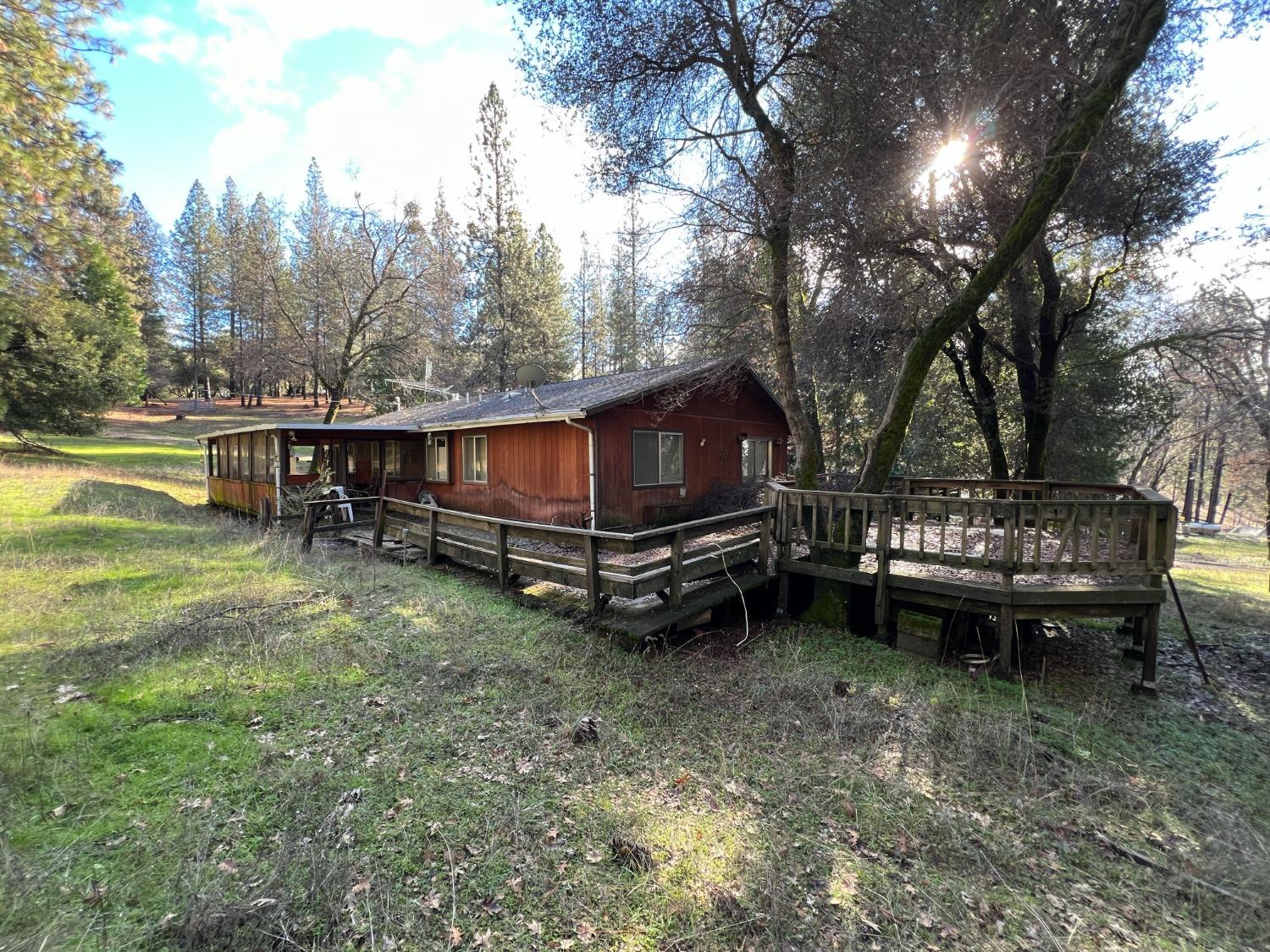 a view of a house with a yard and sitting area