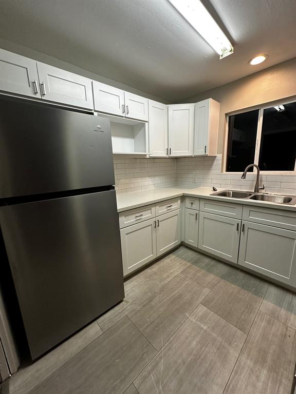 a kitchen with a sink stainless steel appliances and cabinets