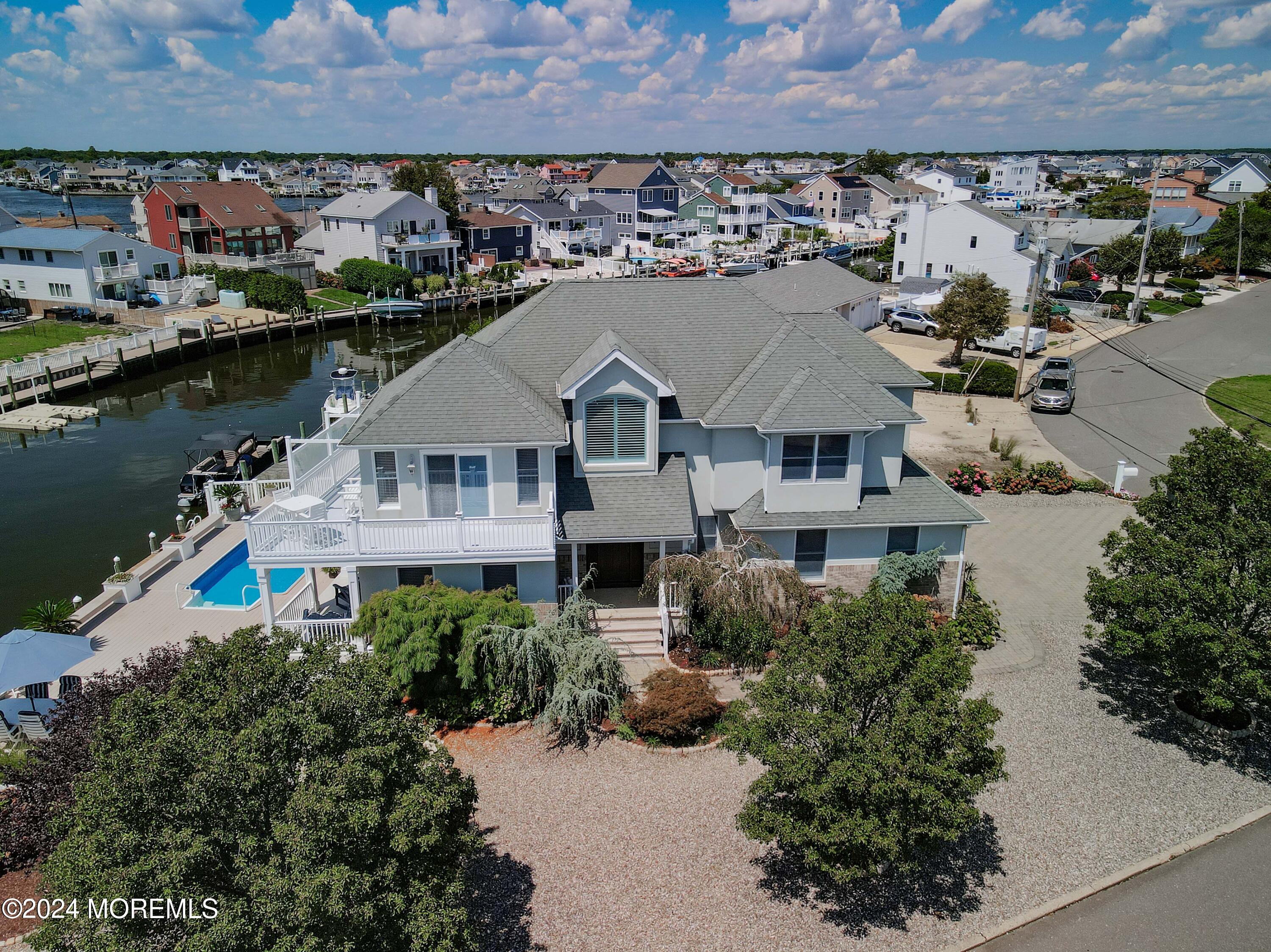 an aerial view of a house with a garden and lake view