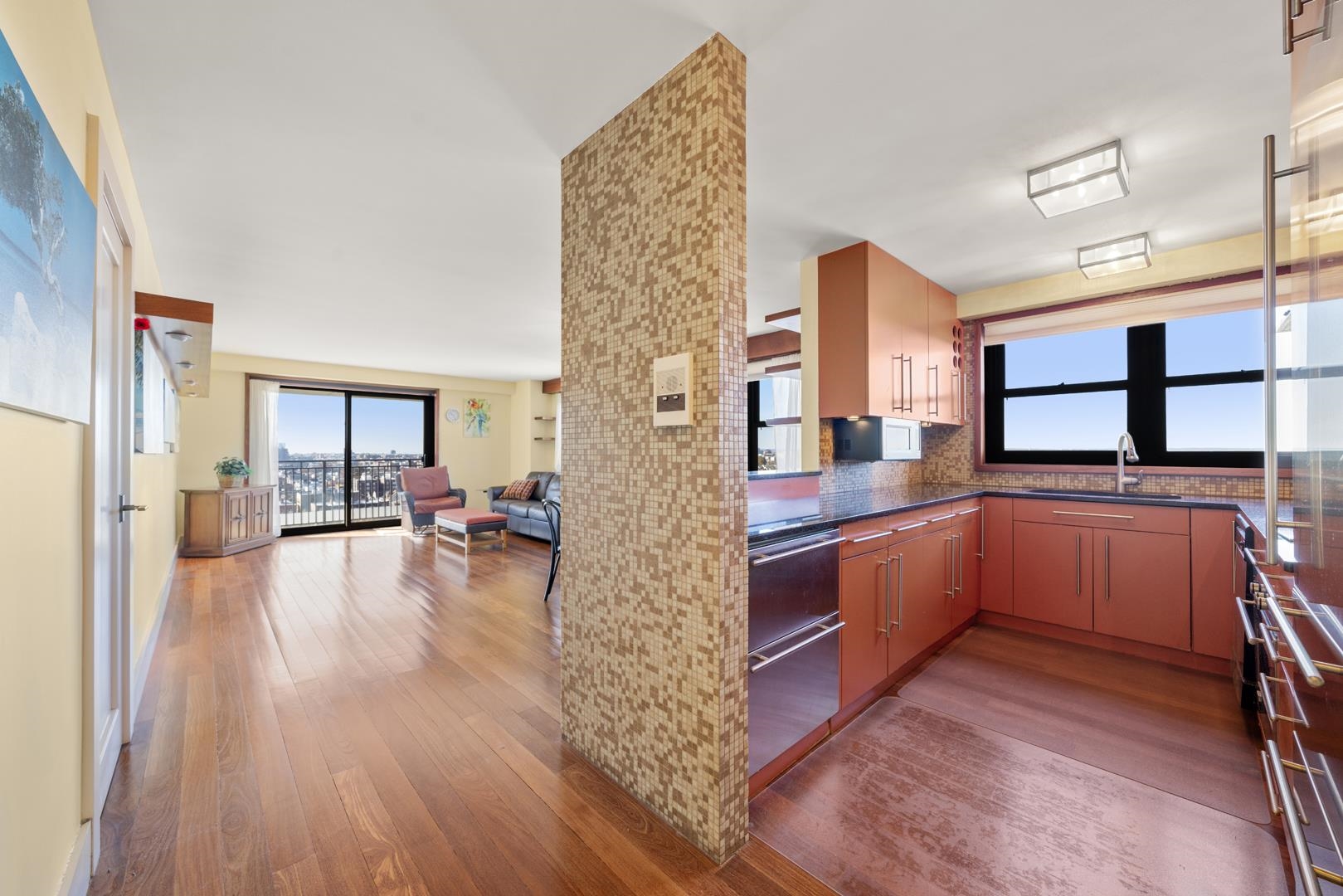 a kitchen with stainless steel appliances granite countertop a stove and wooden floor