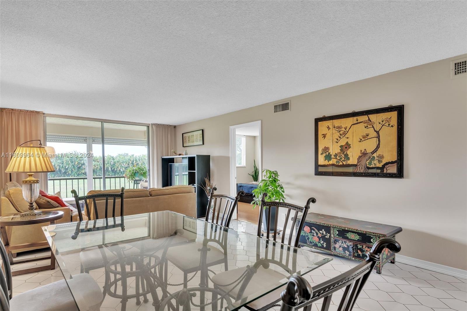 a dining room with furniture a rug and a large window