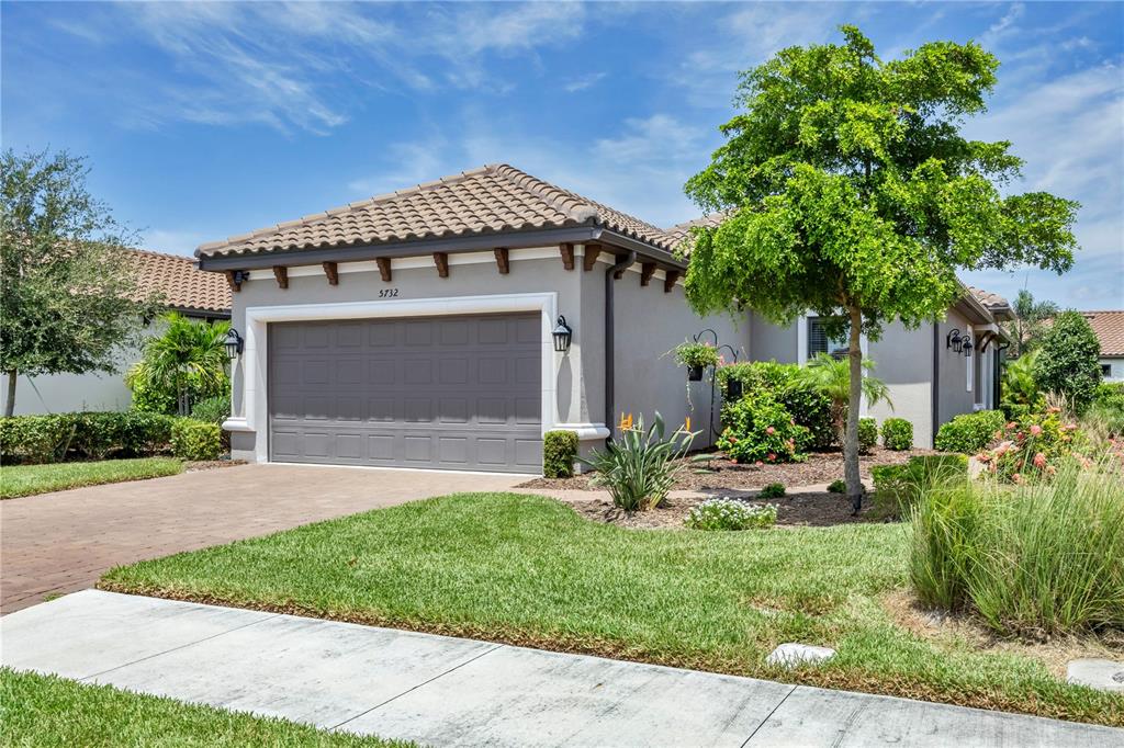 a front view of a house with a yard and garage