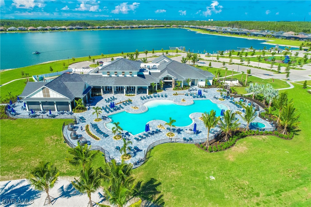 a aerial view of a house with swimming pool patio and outdoor seating