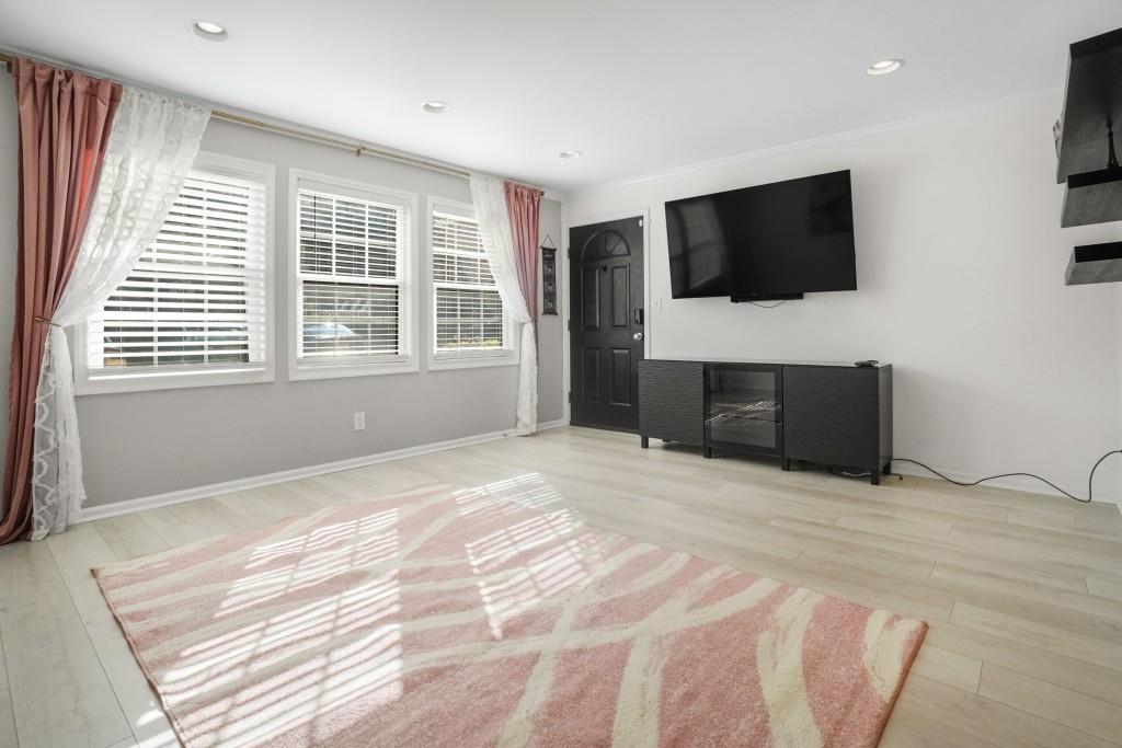 a view of a livingroom with a flat screen tv and windows