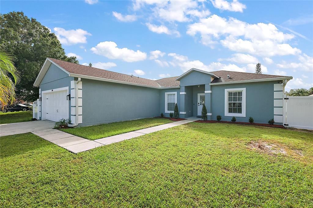 a view of a house with a backyard