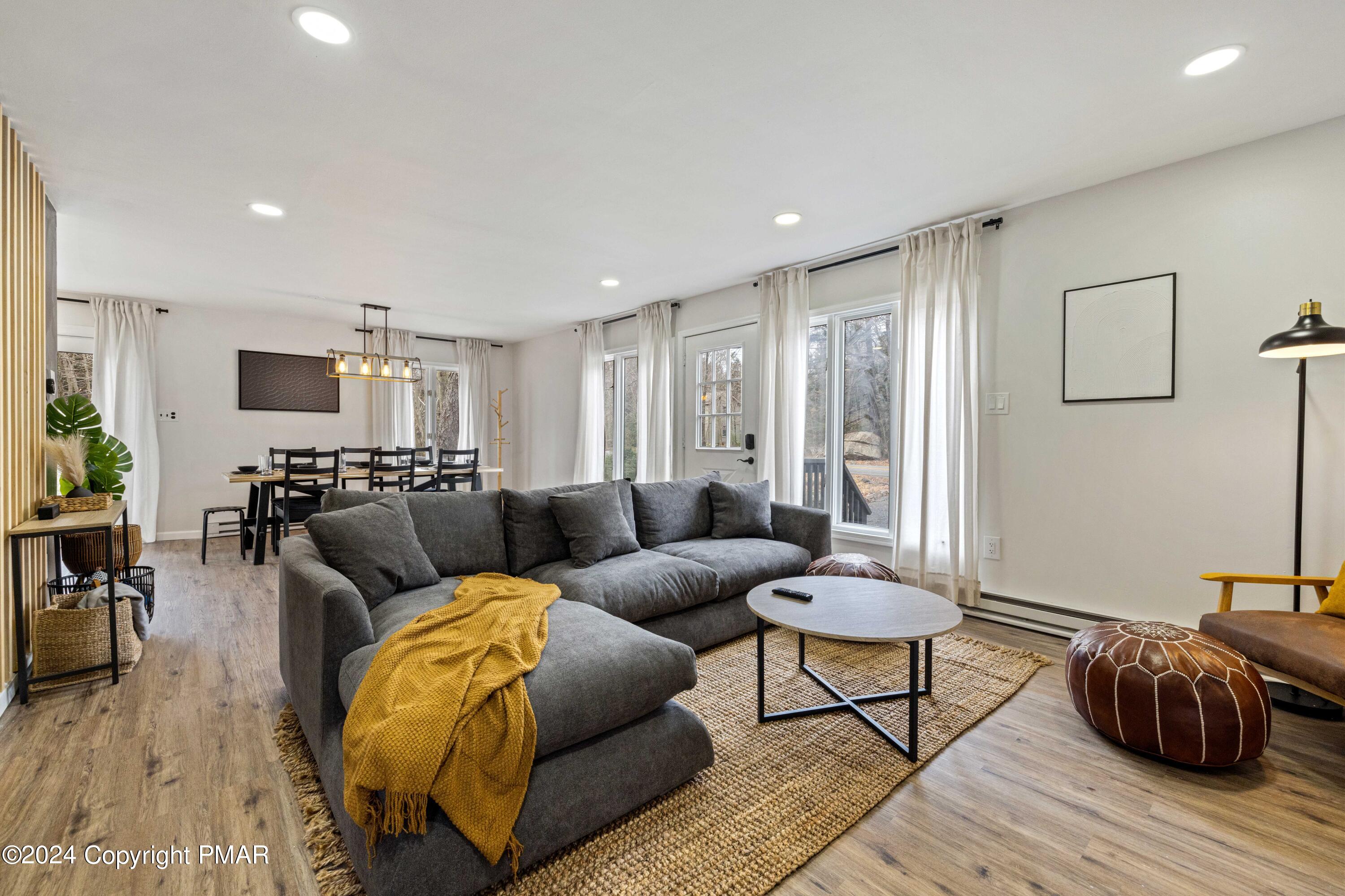 a living room with furniture and wooden floor