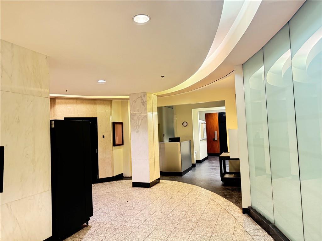 a view of a hallway with furniture and closet