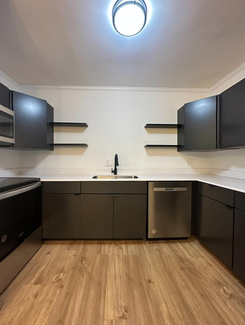 a kitchen with a sink and cabinets