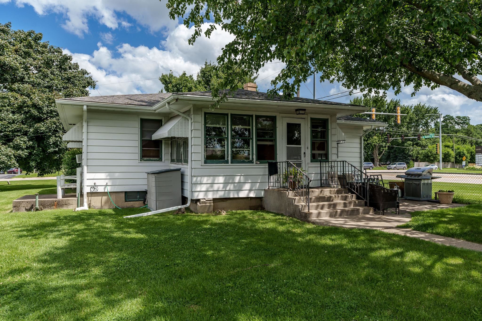 a view of a house with a yard porch and sitting area