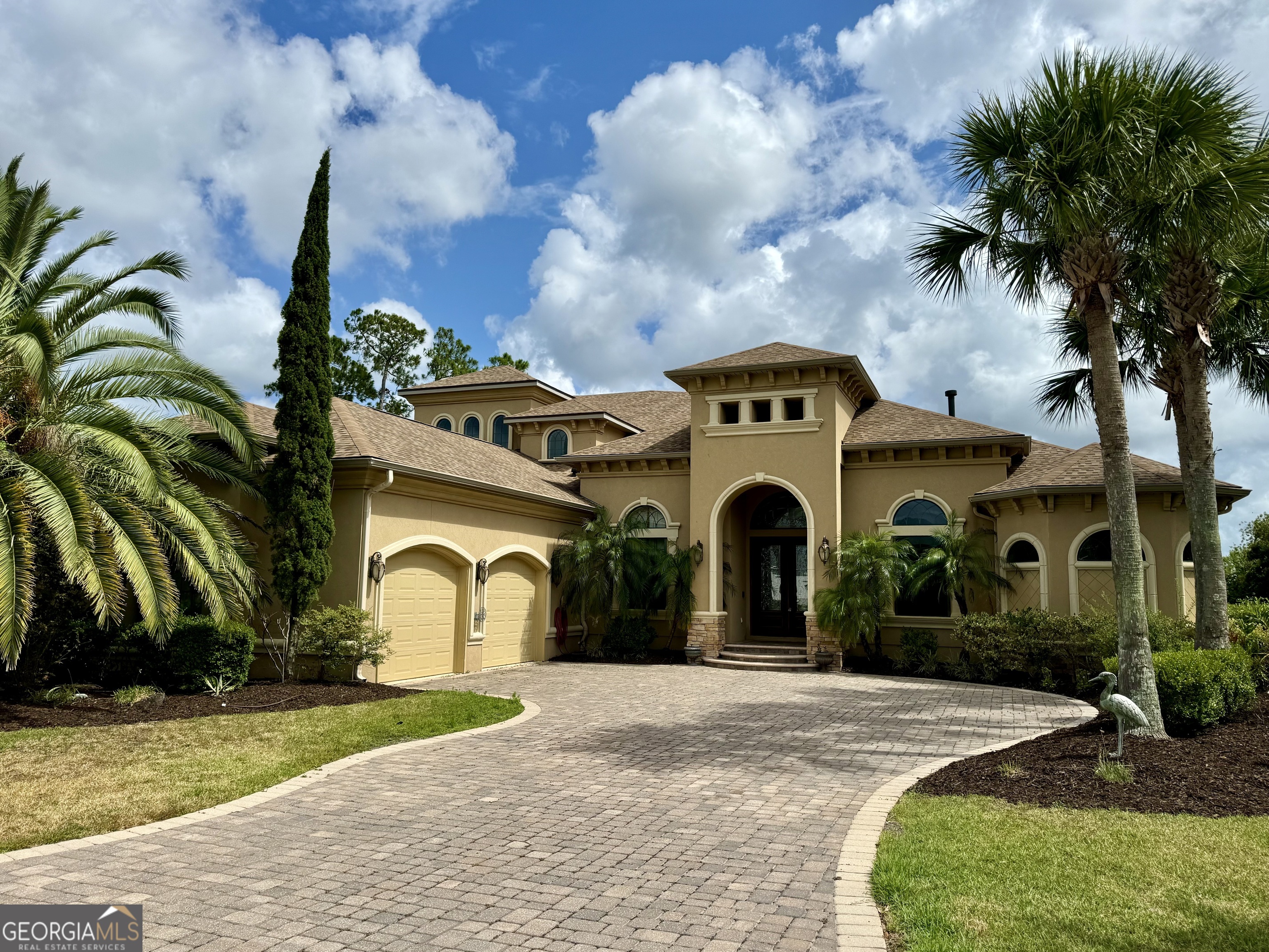 a front view of a house with a garden