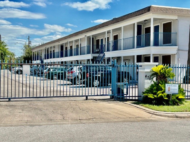 a front view of a building with a garden