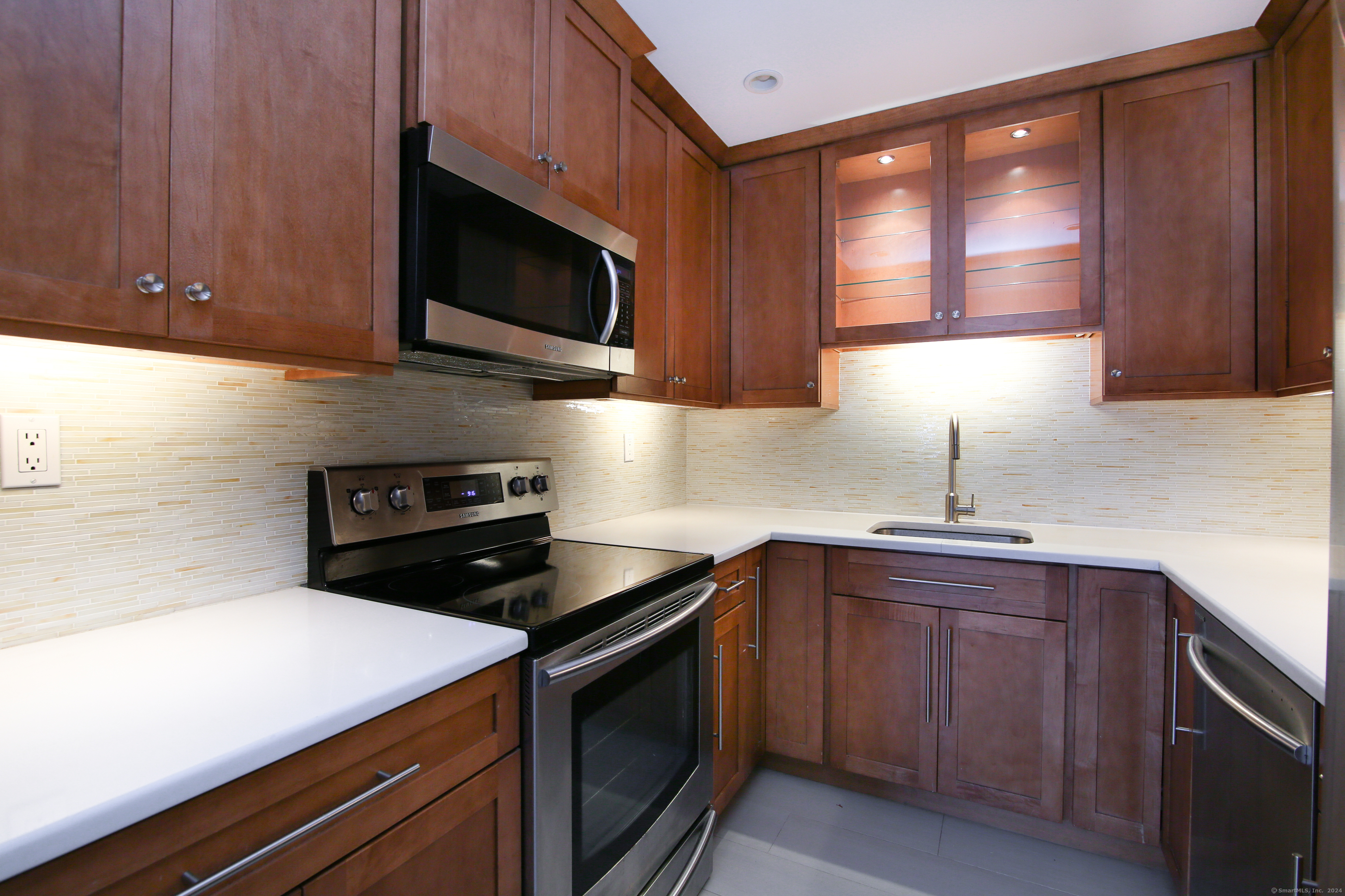 a kitchen with a sink stove and microwave