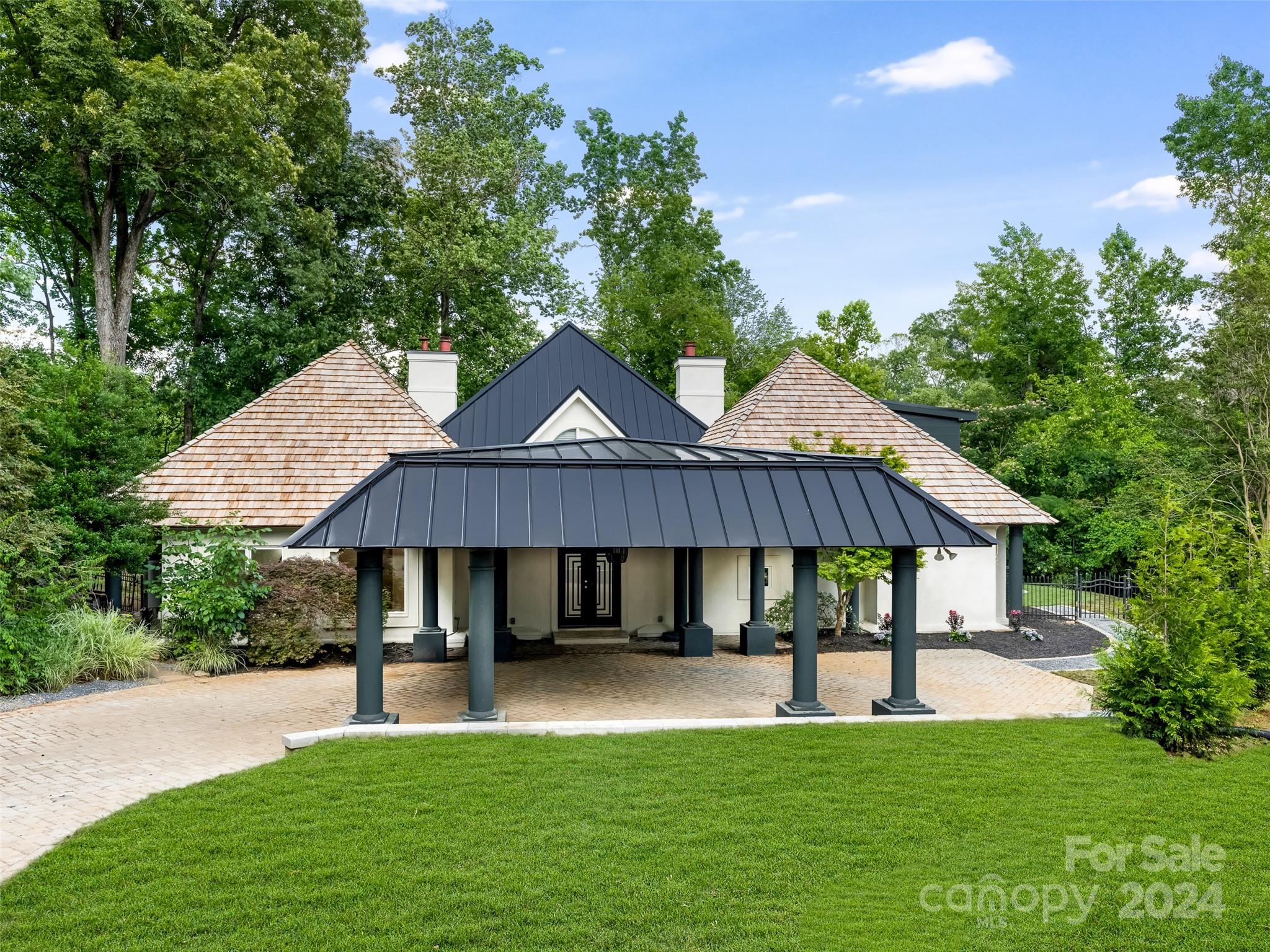 a view of a house with a yard and sitting area