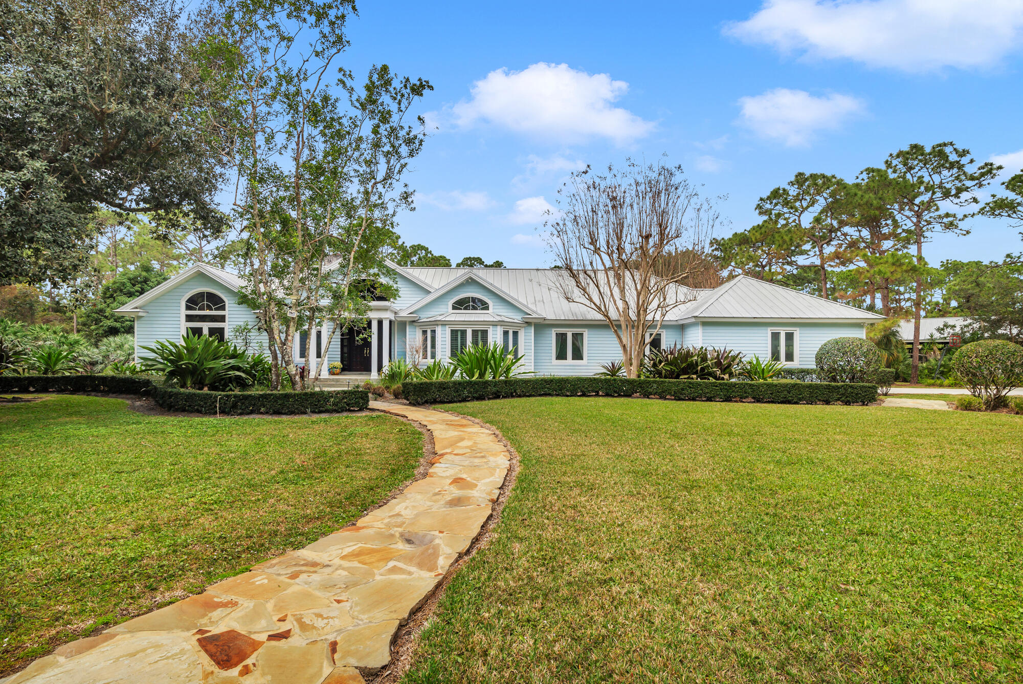 a view of house with garden space and swimming pool