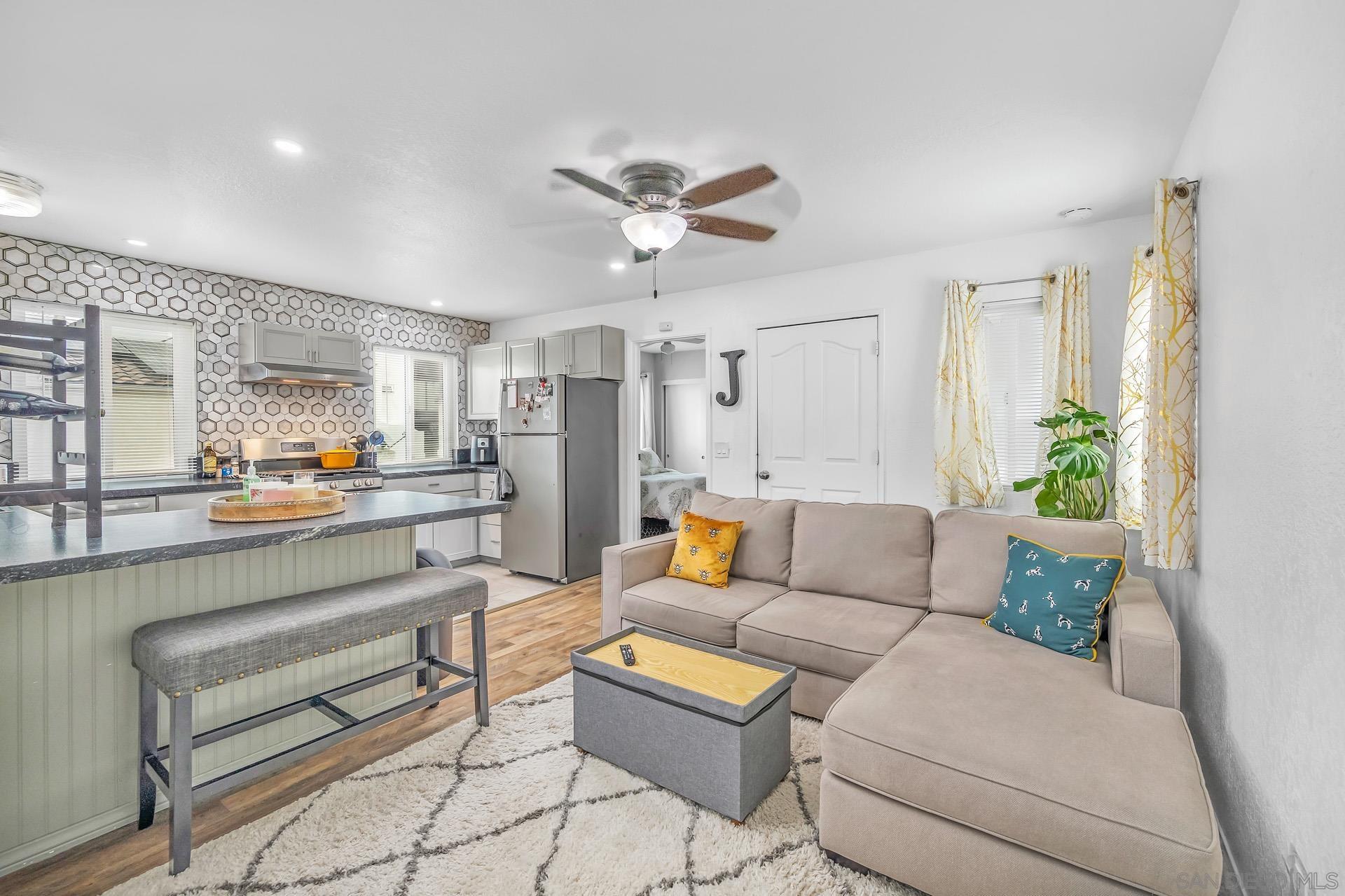 a living room with furniture and kitchen view