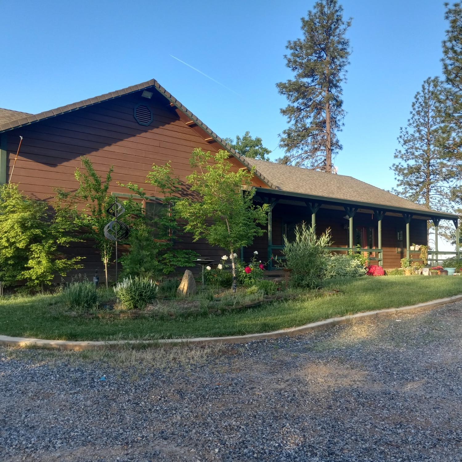 a front view of house with yard and green space