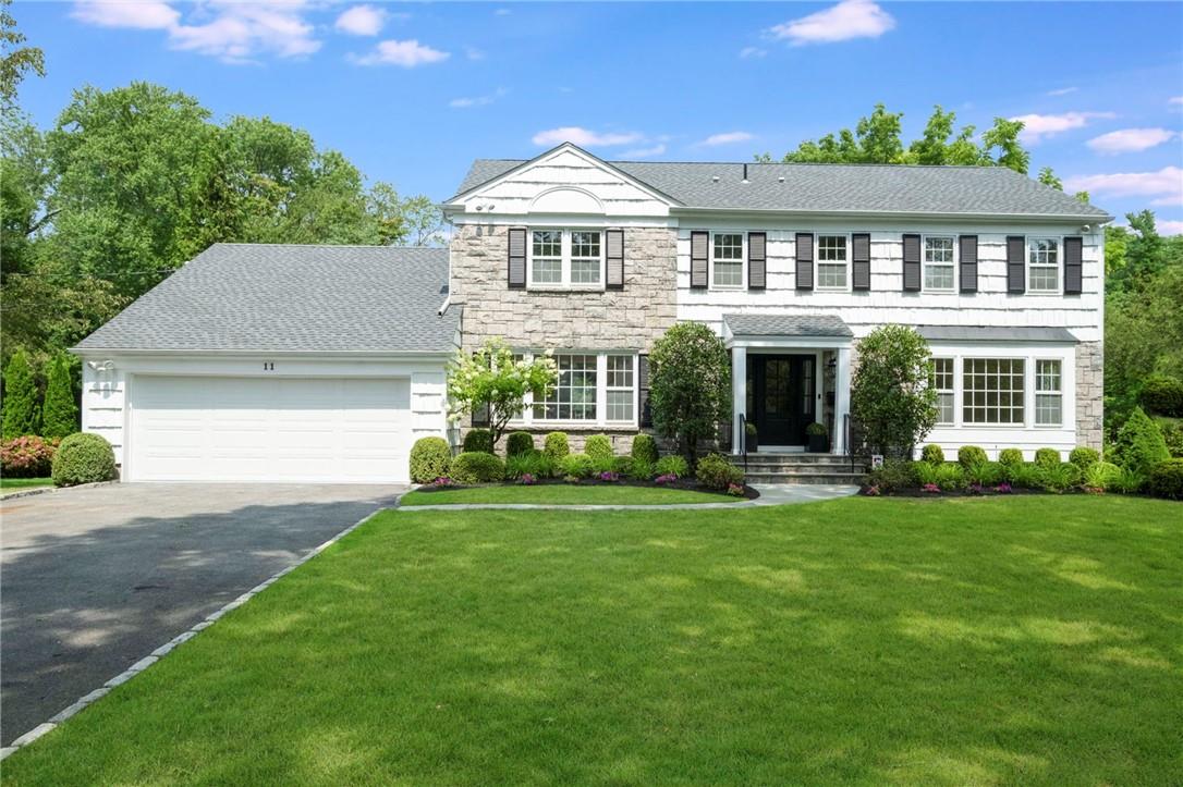 a front view of a house with a yard and garage