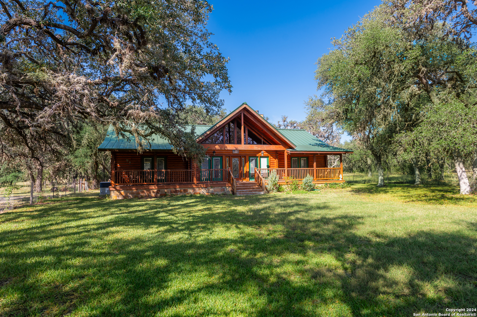 a front view of a house with swimming pool having outdoor seating