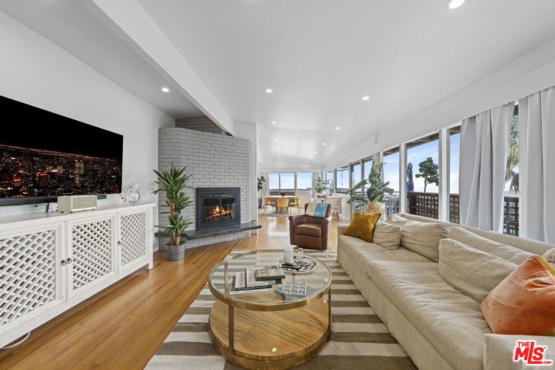 a living room with furniture fireplace and flat screen tv