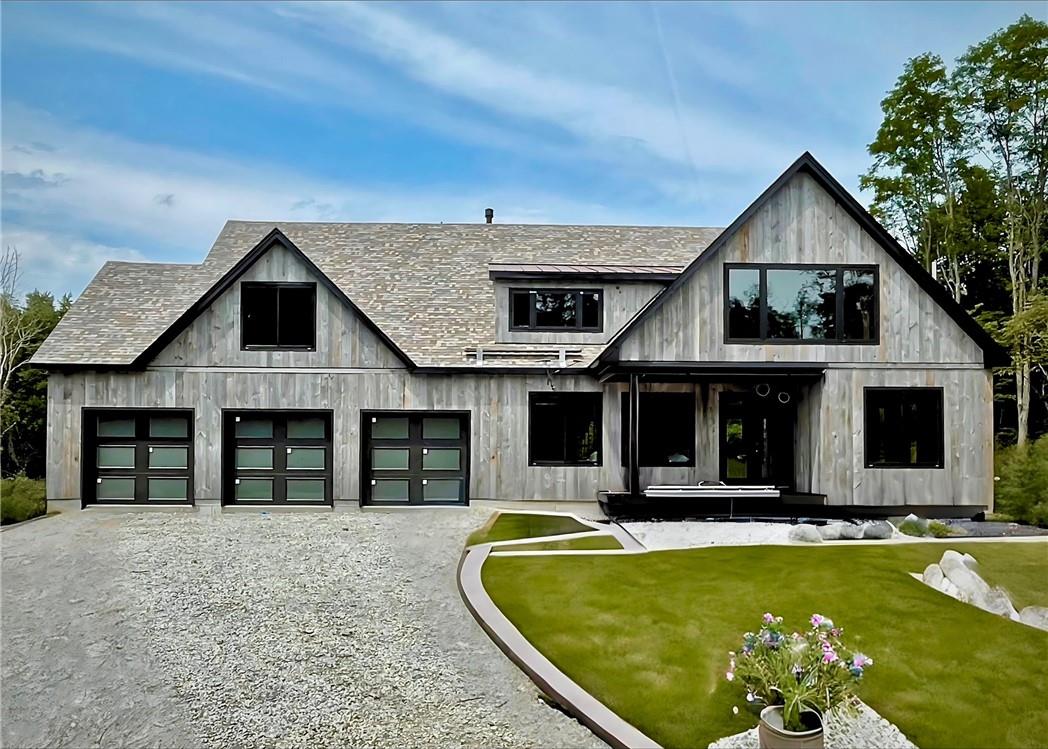 a front view of house with yard outdoor seating and barbeque oven