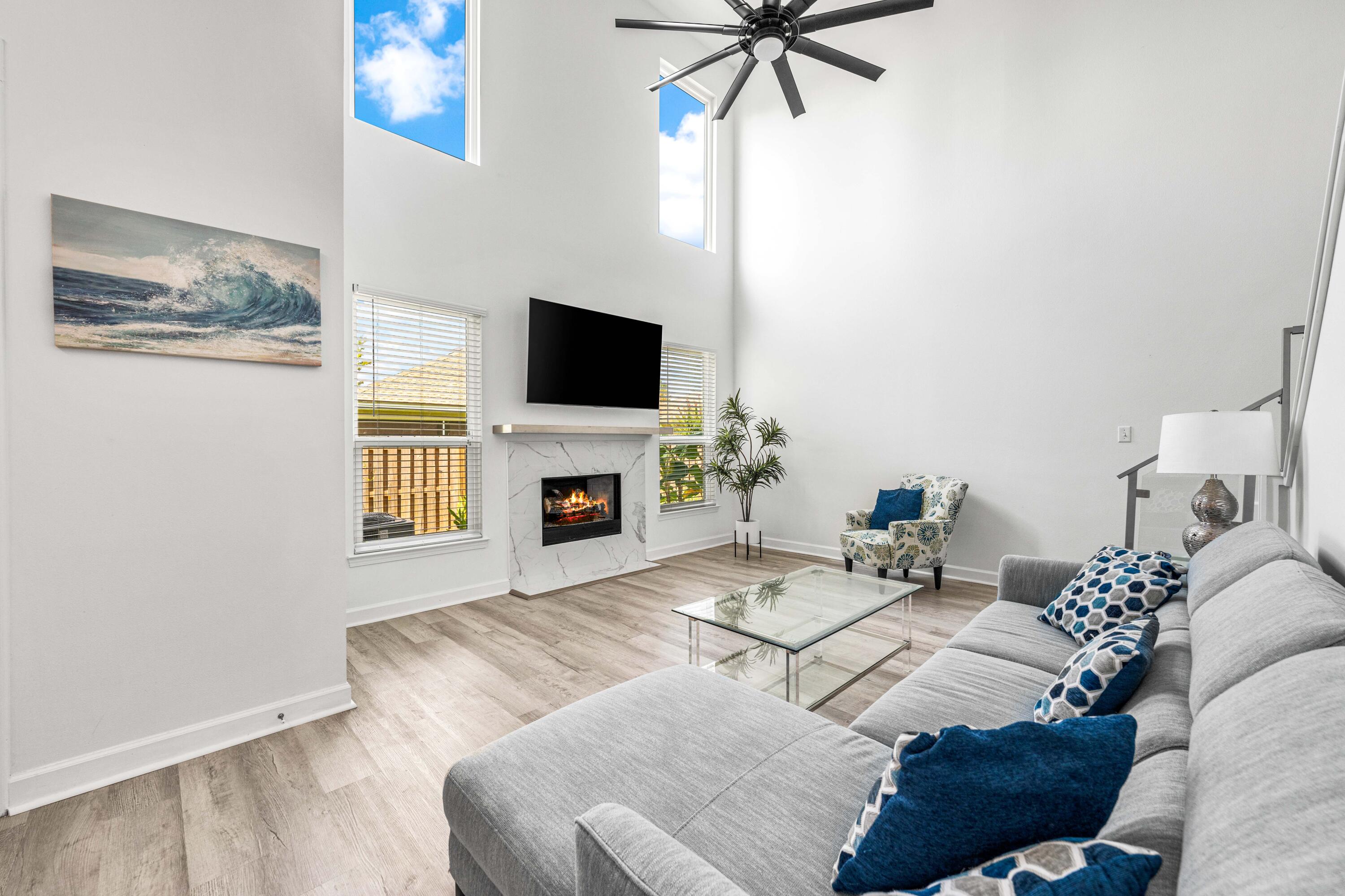 a living room with furniture a fireplace and a flat screen tv