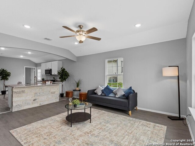 a living room with furniture and kitchen view