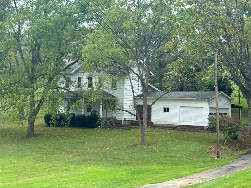 a view of house with a yard