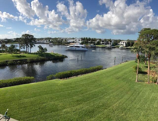 a view of a lake with houses in the back