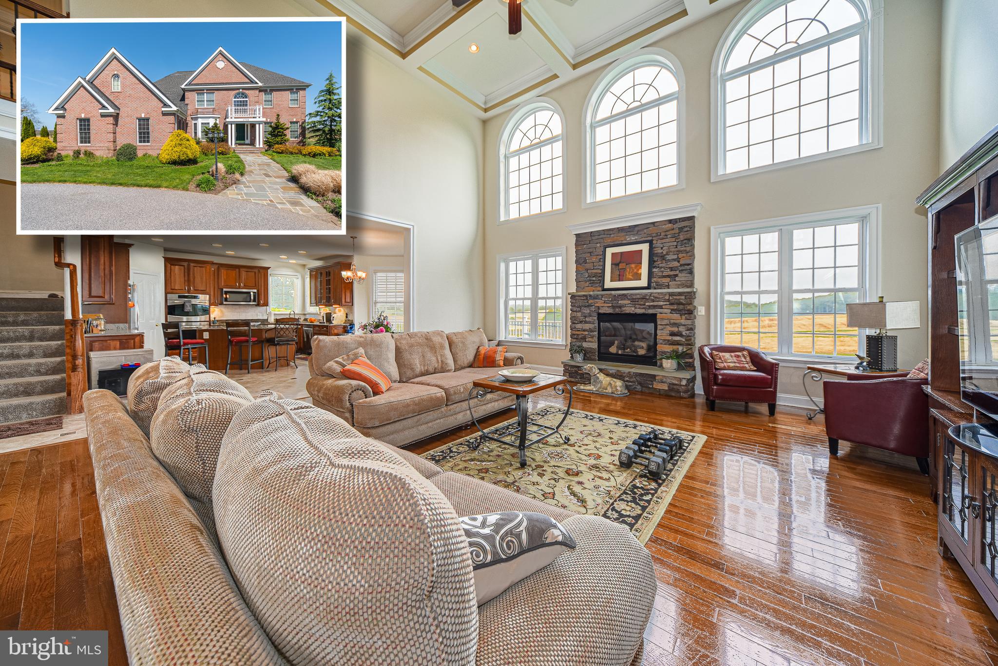 a living room with furniture fireplace and a large window