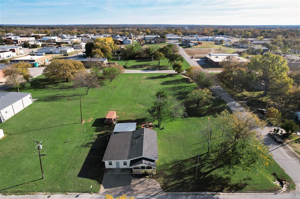 an aerial view of a house with a yard