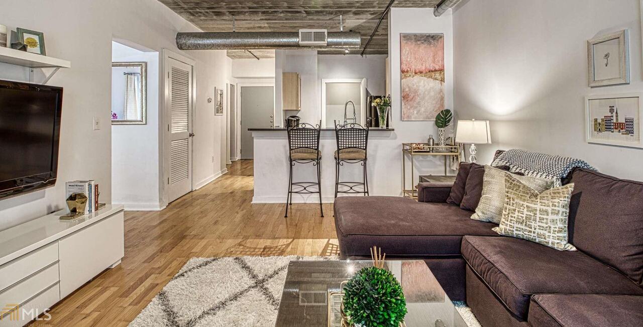 a living room with furniture and a flat screen tv