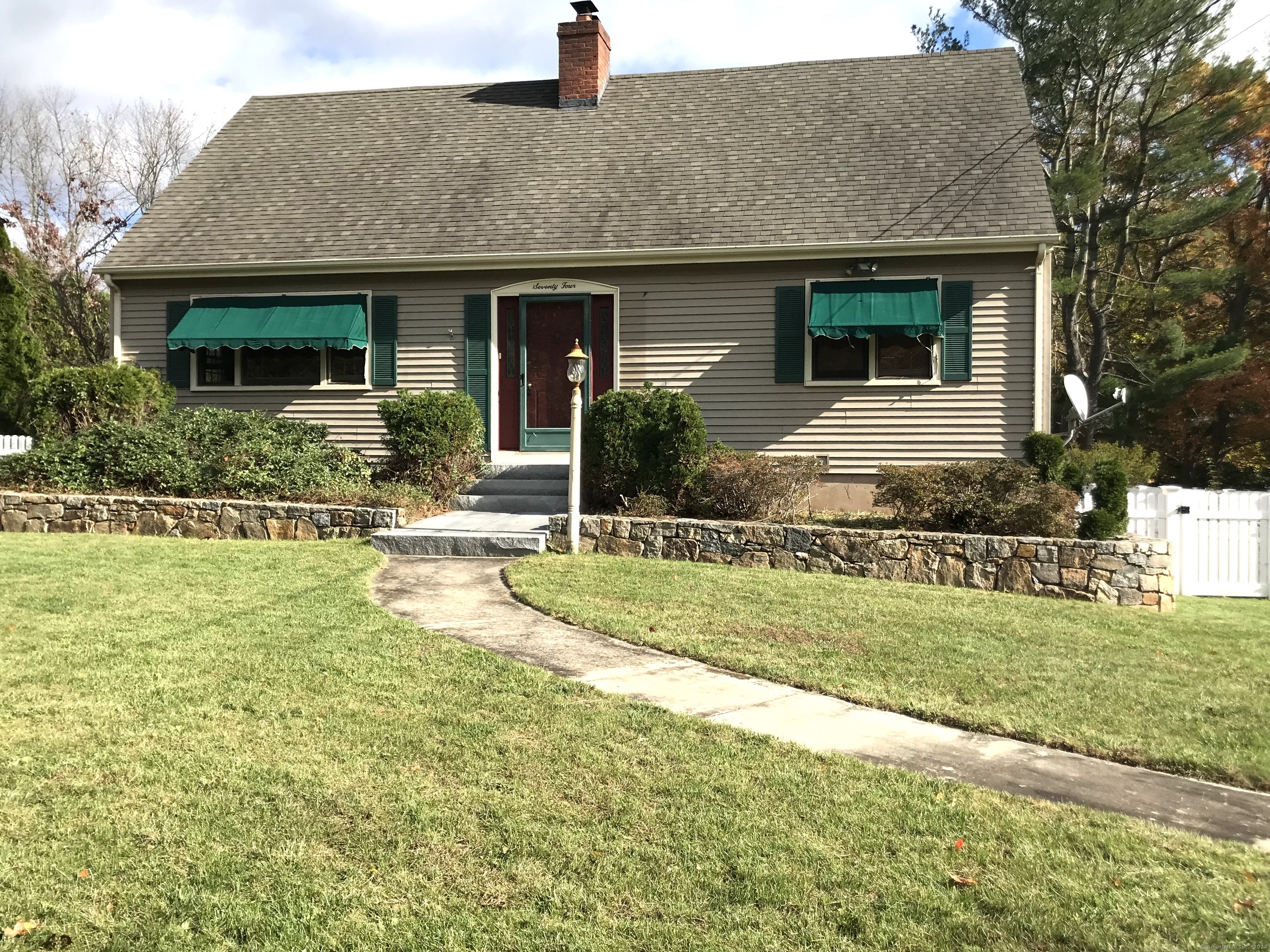 a front view of house with yard and green space