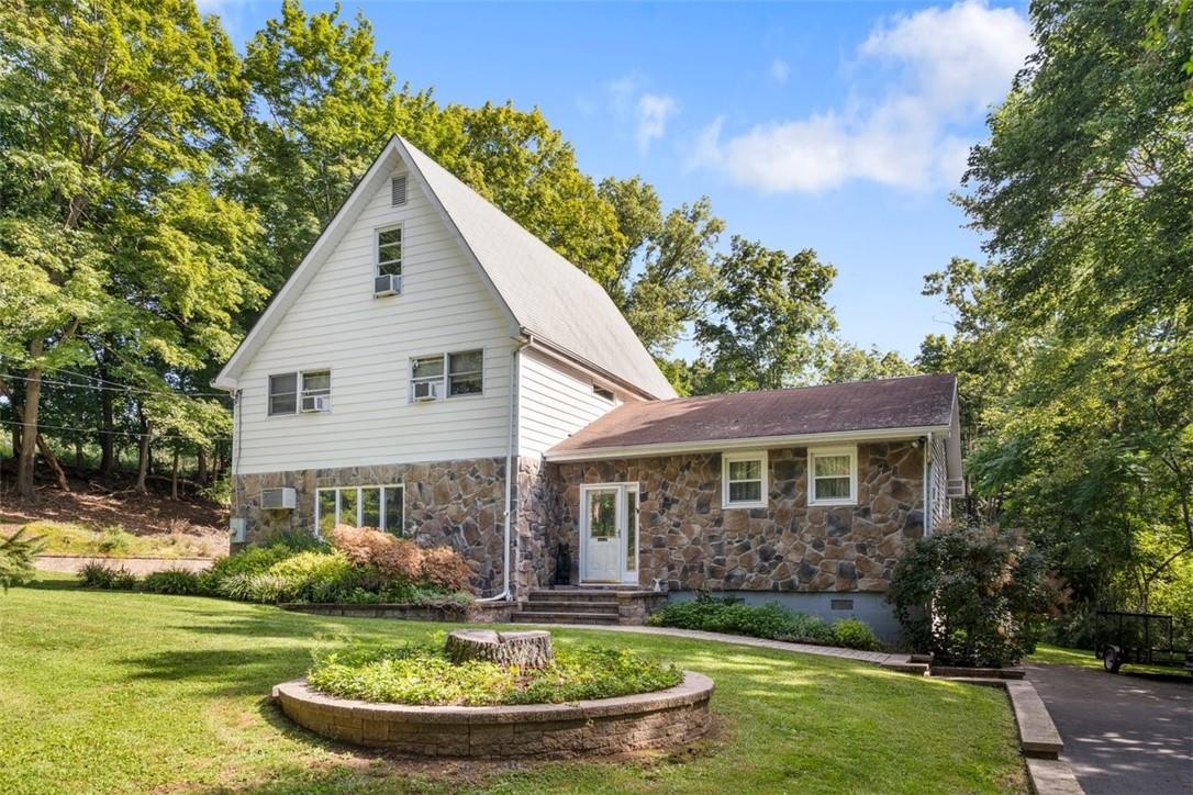 View of property featuring a front lawn