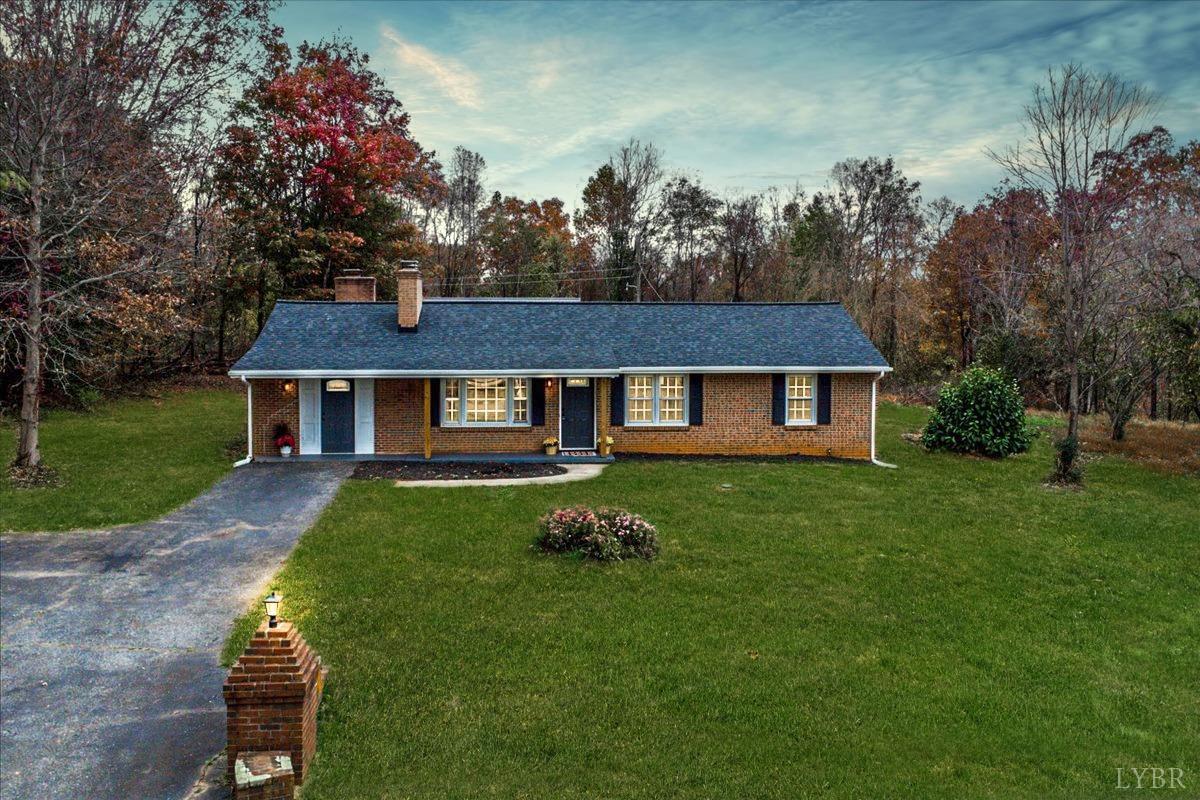 a aerial view of a house with a yard table and chairs