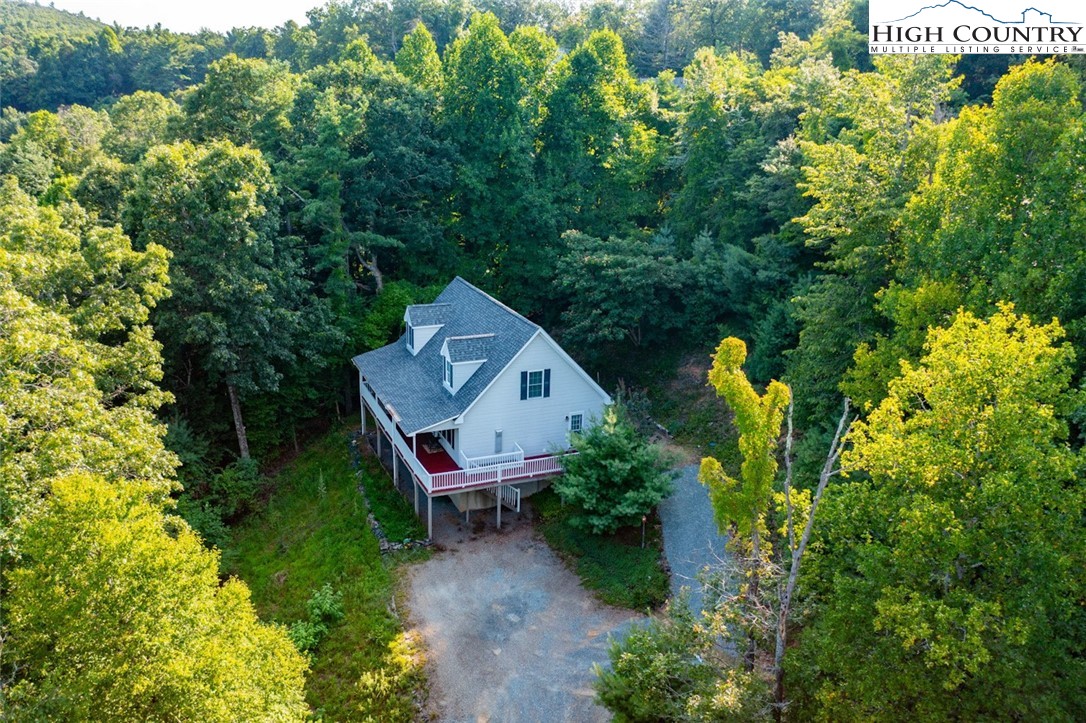 an aerial view of a house with a yard table and chairs