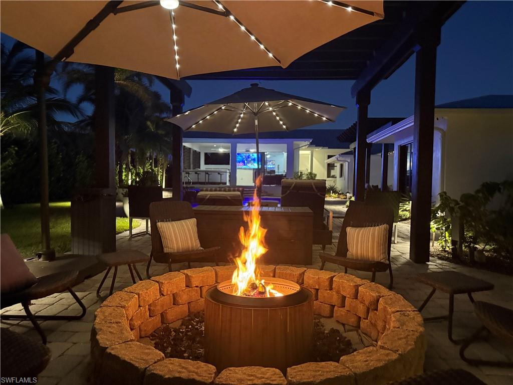 Patio at twilight featuring a fire pit