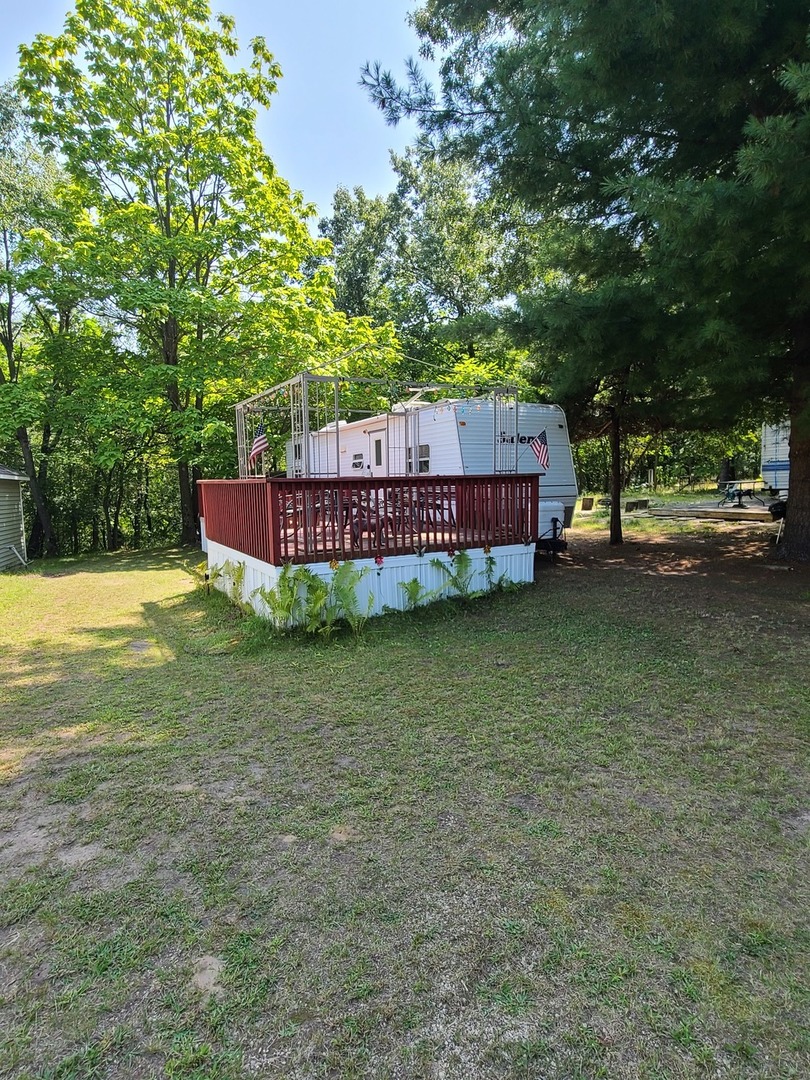 a view of a house with a yard balcony and sitting area