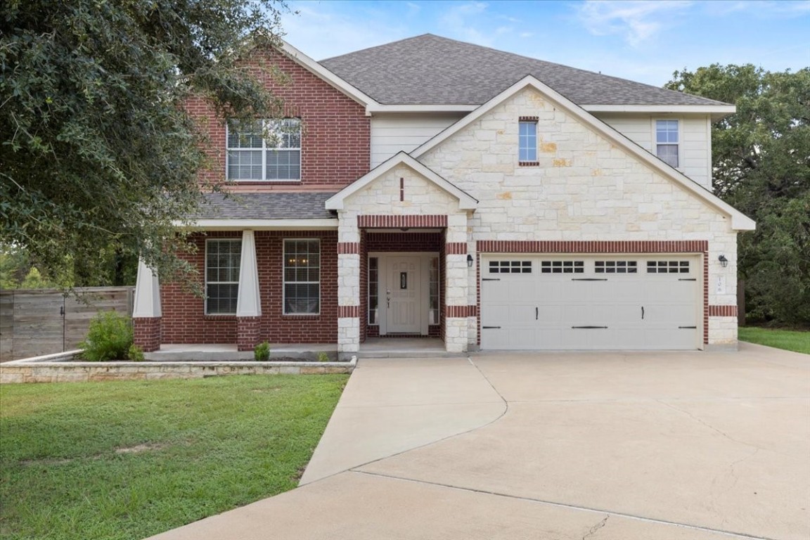 a view of a house with a yard and garage