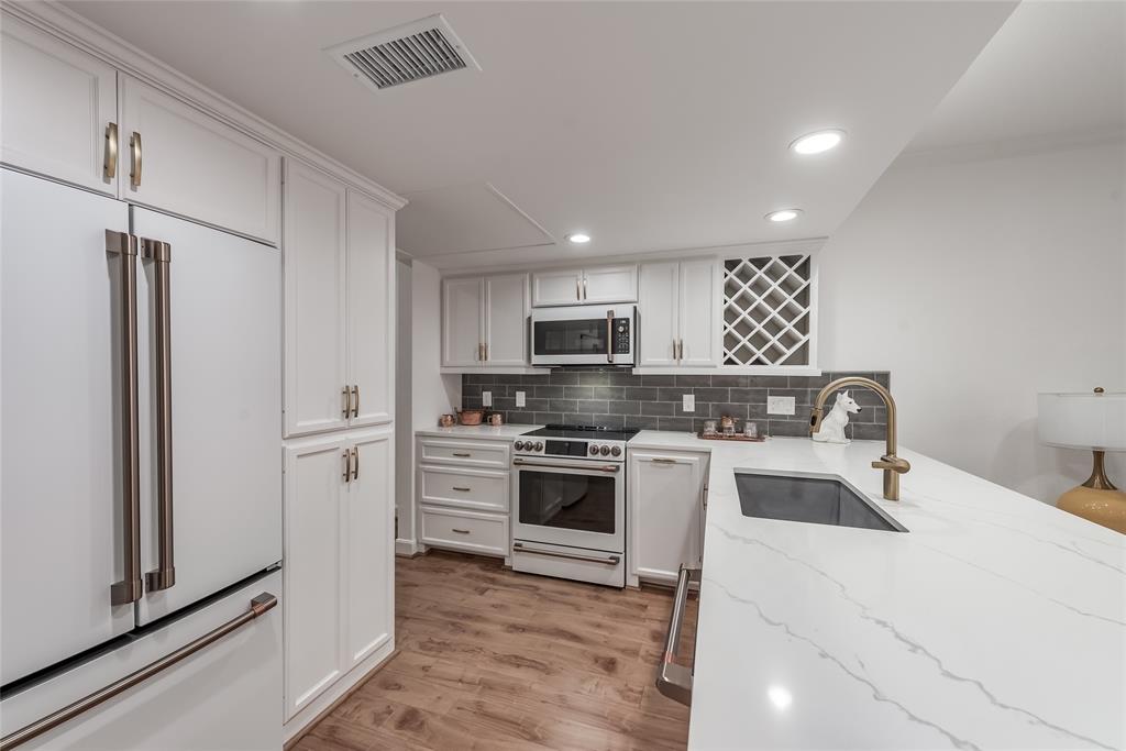 a kitchen with a refrigerator stove and sink