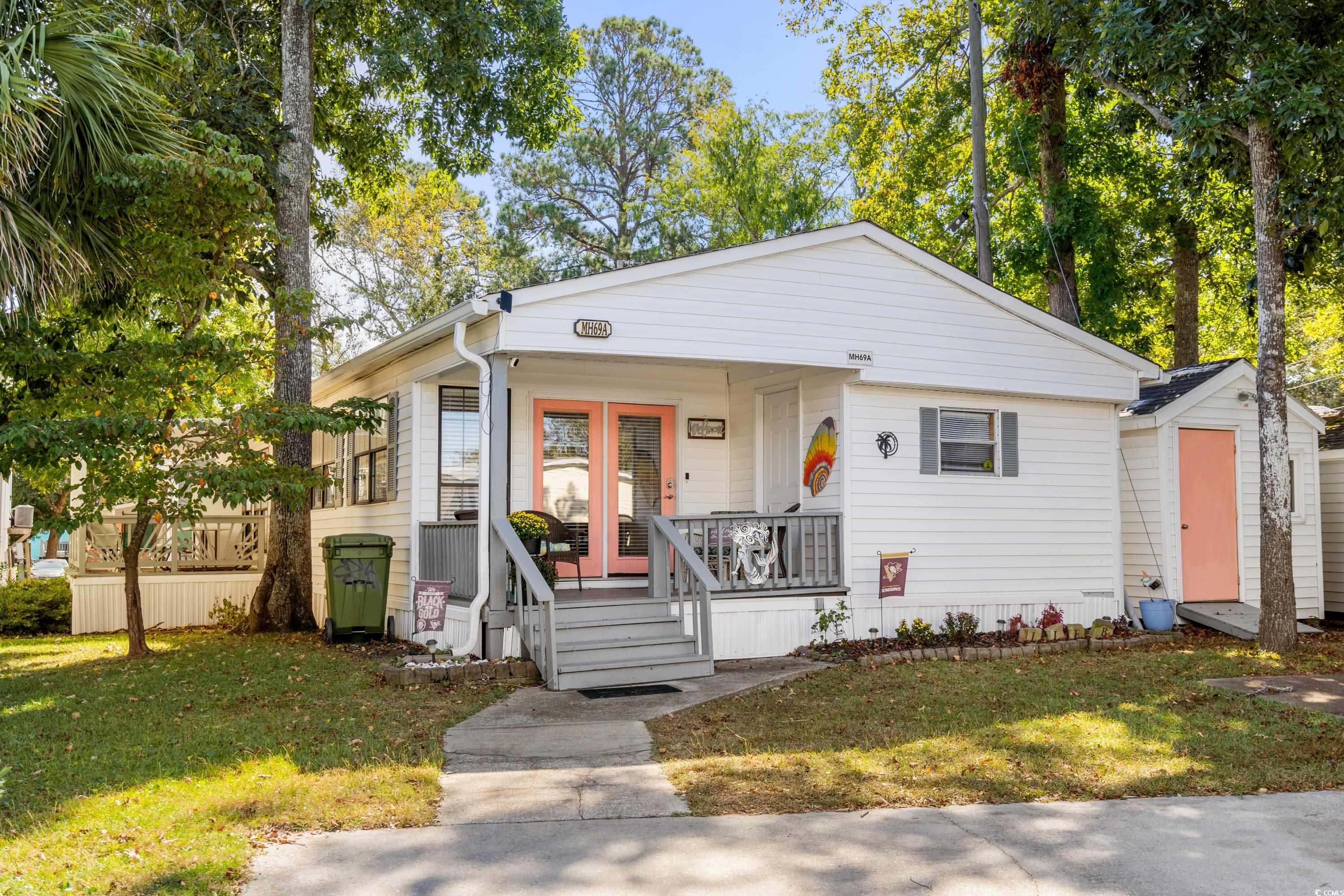 Bungalow with covered porch and a front yard