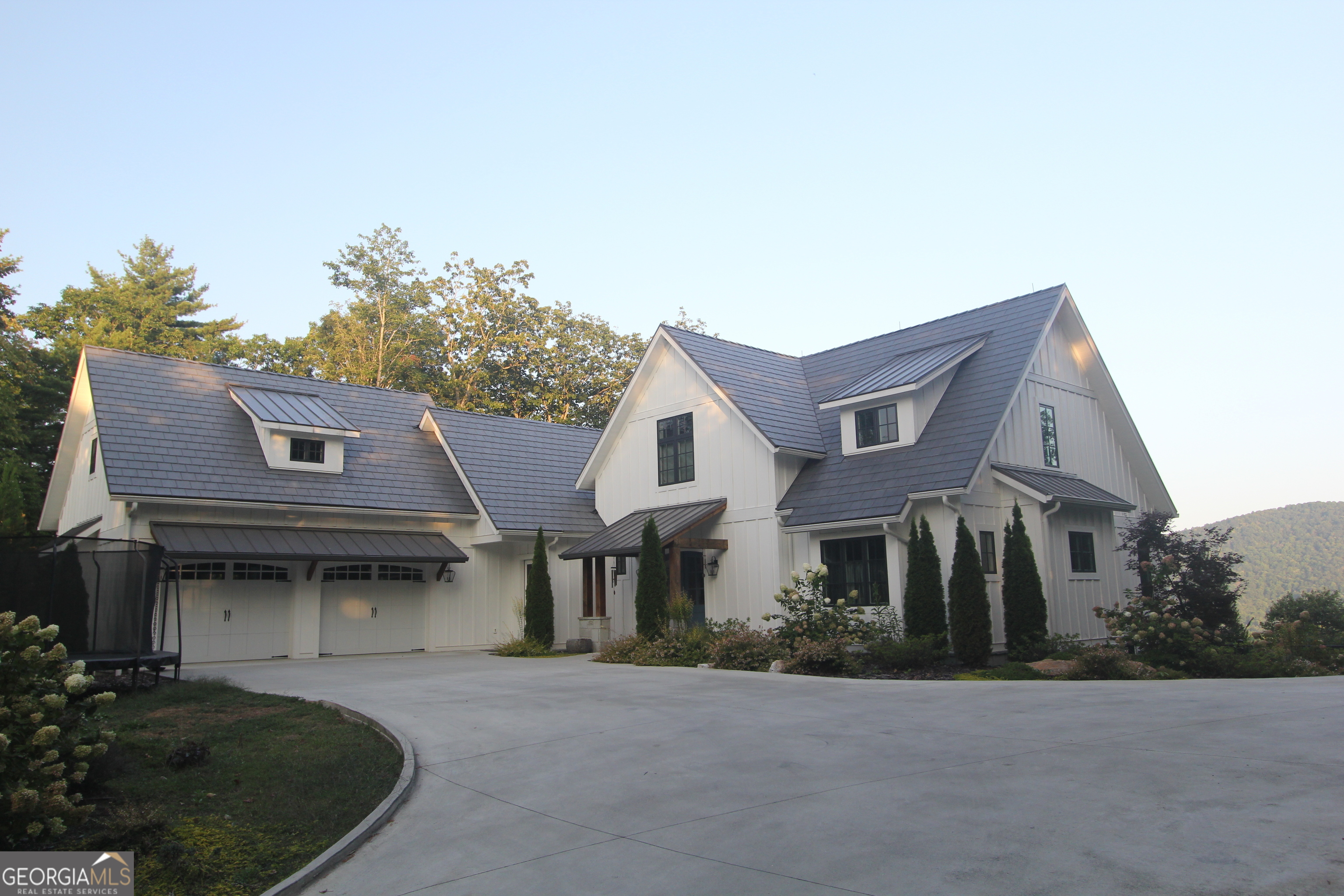 a front view of a house with a garden