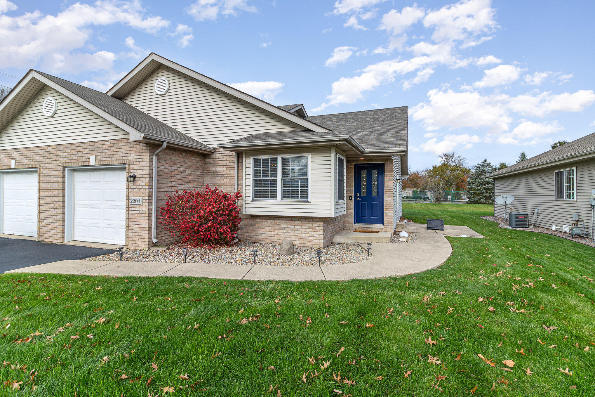 a front view of house with a garden and patio