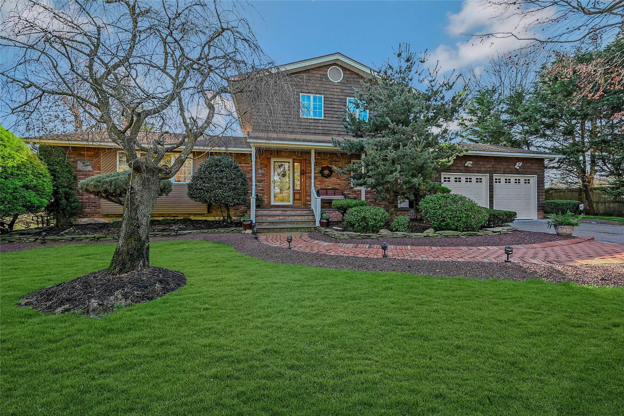 View of front of house featuring a front yard and a garage